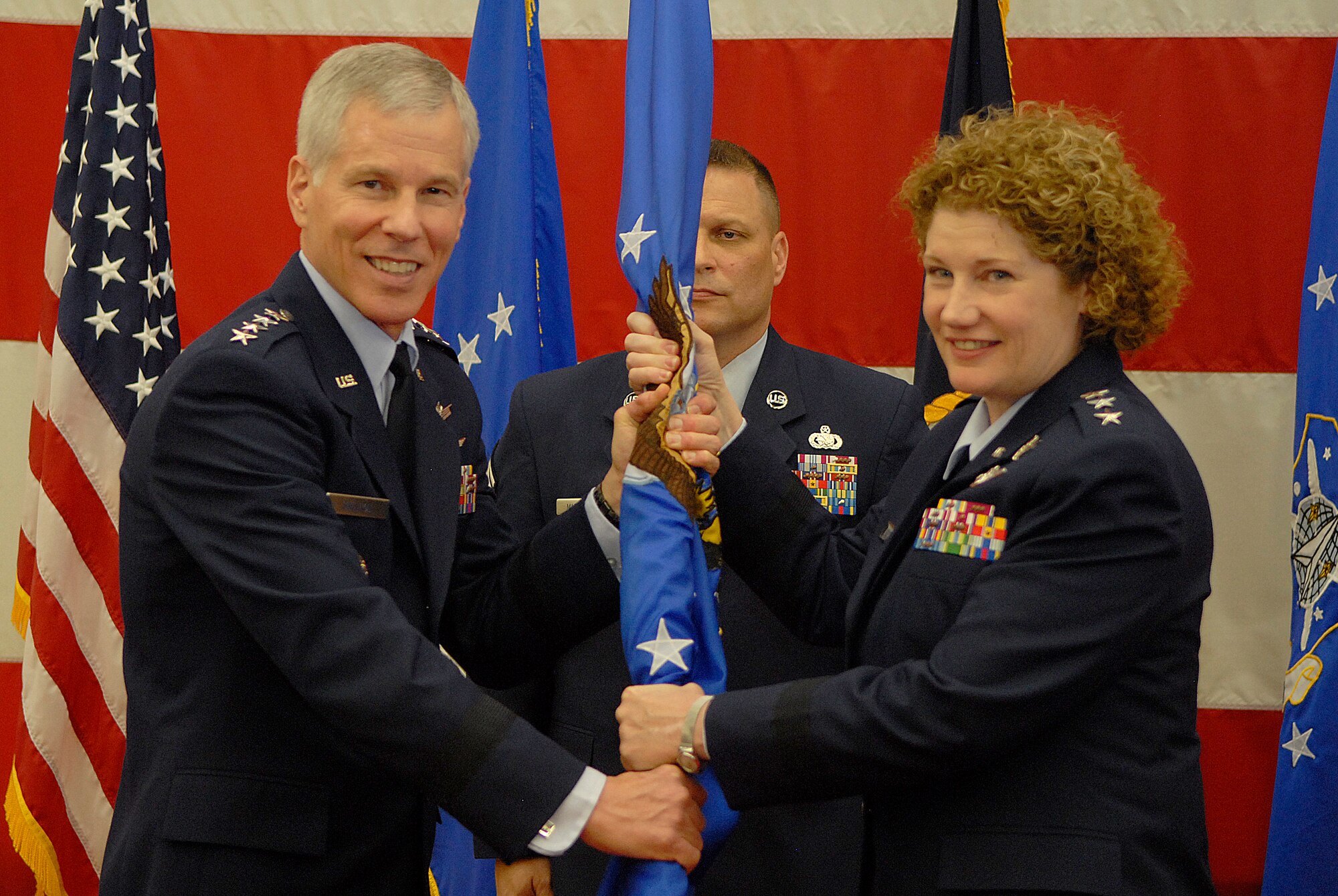 VANDENBERG AIR FORCE BASE, Calif. -- Gen William Shelton, the Air Force Space Command commander, hands the guidon to Lt Gen Susan Helms, the 14th Air Force commander at the Joint Air and Space Operations Center during the 14th Air Force Change of Command here Friday, Jan. 21, 2011. Lt Gen Larry James, former 14th Air Force commander, relinquished the command to General Helms.  (U.S. Air Force photo/Senior Airman Andrew Satran) 
