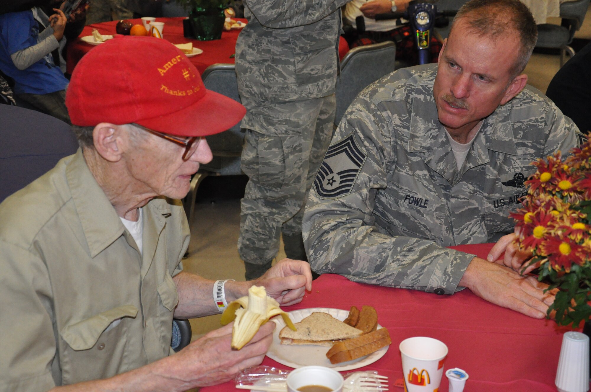 WRIGHT-PATTERSON AIR FORCE BASE, Ohio - Chief Master Sgt. Brian Fowle, 445th Aeromedical Evacuation Squadron, visits with veteran Wesley Shaffer at the Dayton VA Medical Center, Dayton, Ohio, Dec. 3, 2011. 445th Airmen attend the annual Christmas party and provide gifts and companionship to local VA residents. (U.S. Air Force photo/Tech. Sgt. Jeremy Caskey)