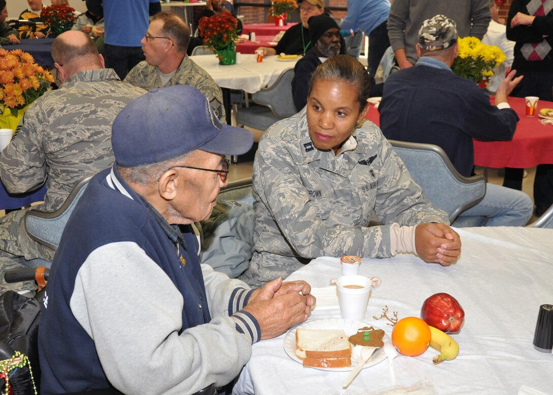 WRIGHT-PATTERSON AIR FORCE BASE, Ohio - Capt. Jenice Brown, 445th Aeromedical Evacuation Squadron flight nurse, visits with Army Air Corps veteran Charlie Brown at the Dayton VA Medical Center, Dayton, Ohio, Dec. 3, 2011. 445th Airmen attend the annual Christmas party and provide gifts and companionship to local VA residents. (U.S. Air Force photo/Senior Airman Matthew Cook)