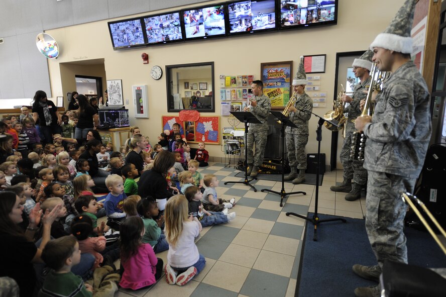 MINOT AIR FORCE BASE, N.D. -- The U.S. Air Force Heartland of America Band performed an assortment of Christmas music, including Frosty the Snowman and Jingle Bells, for children at the Child Development Center here Dec. 16. The band toured Minot AFB for three days, performing at various locations, spreading good cheers and improving morale. (U.S. Air Force photo/Airman 1st Class Stephanie Ashley)