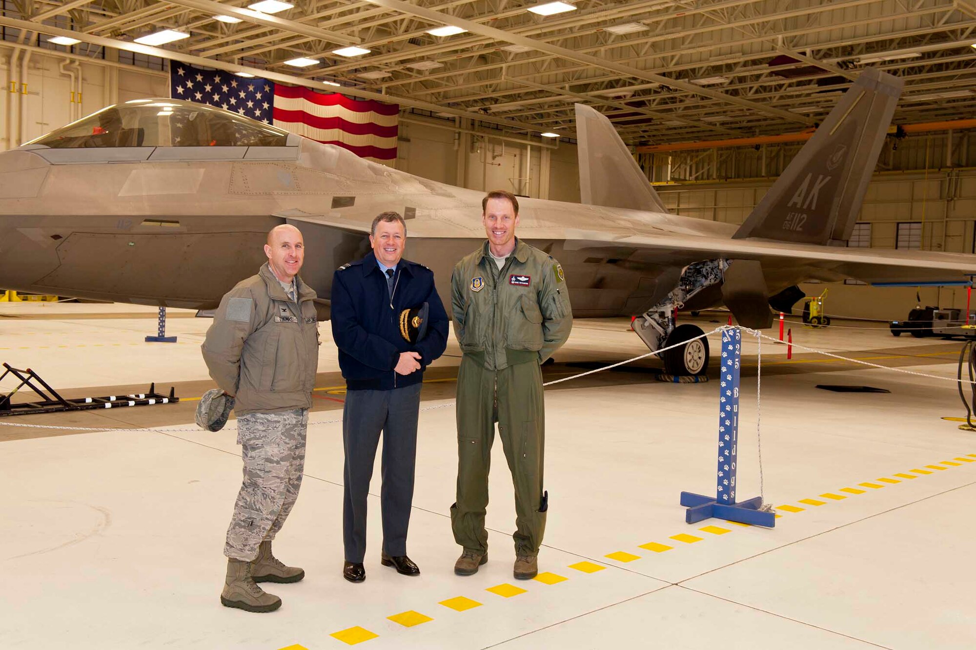 Col. Ed Thomas, 673rd Mission Support Group commander and Lt. Col. David Piffarerio, 302nd Fighter Squadron commander give Lord Maxwell Beaverbrook, Honorary Inspector General, Royal Auxiliary Air Force, a tour of an F-22 Dec. 13.  Lord Beaverbook is responsible for training for the American equivalent of the Royal Air Force Reserves and was visiting JBER to observe the integration between the active duty and Reserve Air Force units on JBER. (Courtesy Photo)