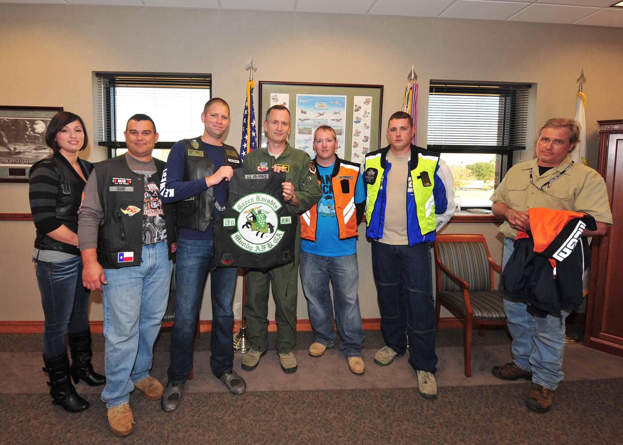 U.S. Air Force Col. Billy Thompson, 23rd Wing commander, takes a group photo with the members of the Green Knights motorcycle club at Moody Air Force Base, Ga., Dec. 19, 2011. The Green Knights presented Col. Thompson with the club colors and invited him to join them for a ride. The Green Knights started at McGuire AFB, N.J. in 1999 and have been operating at Moody since the spring of 2010. (U.S. Air Force photo by Staff Sgt. Stephanie Mancha/Released)
