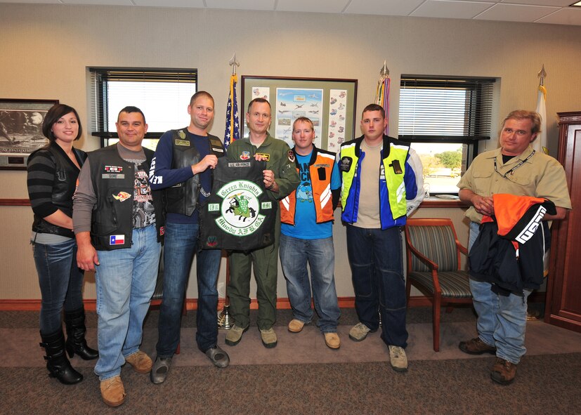 U.S. Air Force Col. Billy Thompson, 23rd Wing commander, takes a group photo with the members of the Green Knights motorcycle club at Moody Air Force Base, Ga., Dec. 19, 2011. The Green Knights presented Col. Thompson with the club colors and invited him to join them for a ride. The Green Knights started at McGuire AFB, N.J. in 1999 and have been operating at Moody since the spring of 2010. (U.S. Air Force photo by Staff Sgt. Stephanie Mancha/Released)
