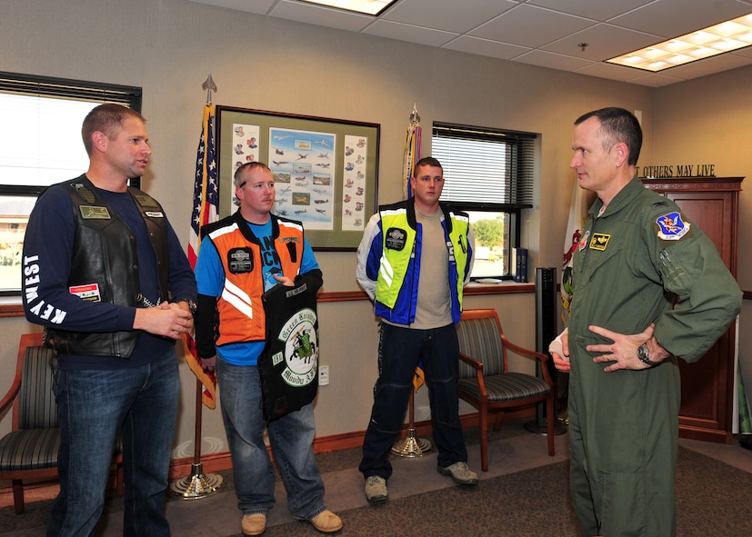 U.S. Air Force Tech. Sgt. Daniel Fleig, 23rd Comptroller Squadron budget analyst and president of the Green Knights motorcycle club speaks to Col. Billy Thompson, 23rd Wing commander about the Green Knights at Moody Air Force Base, Ga., Dec. 19, 2011. The Green Knights hold poker runs to raise money for different charities in the community and host events on base. (U.S. Air Force photo by Staff Sgt. Stephanie Mancha/Released)