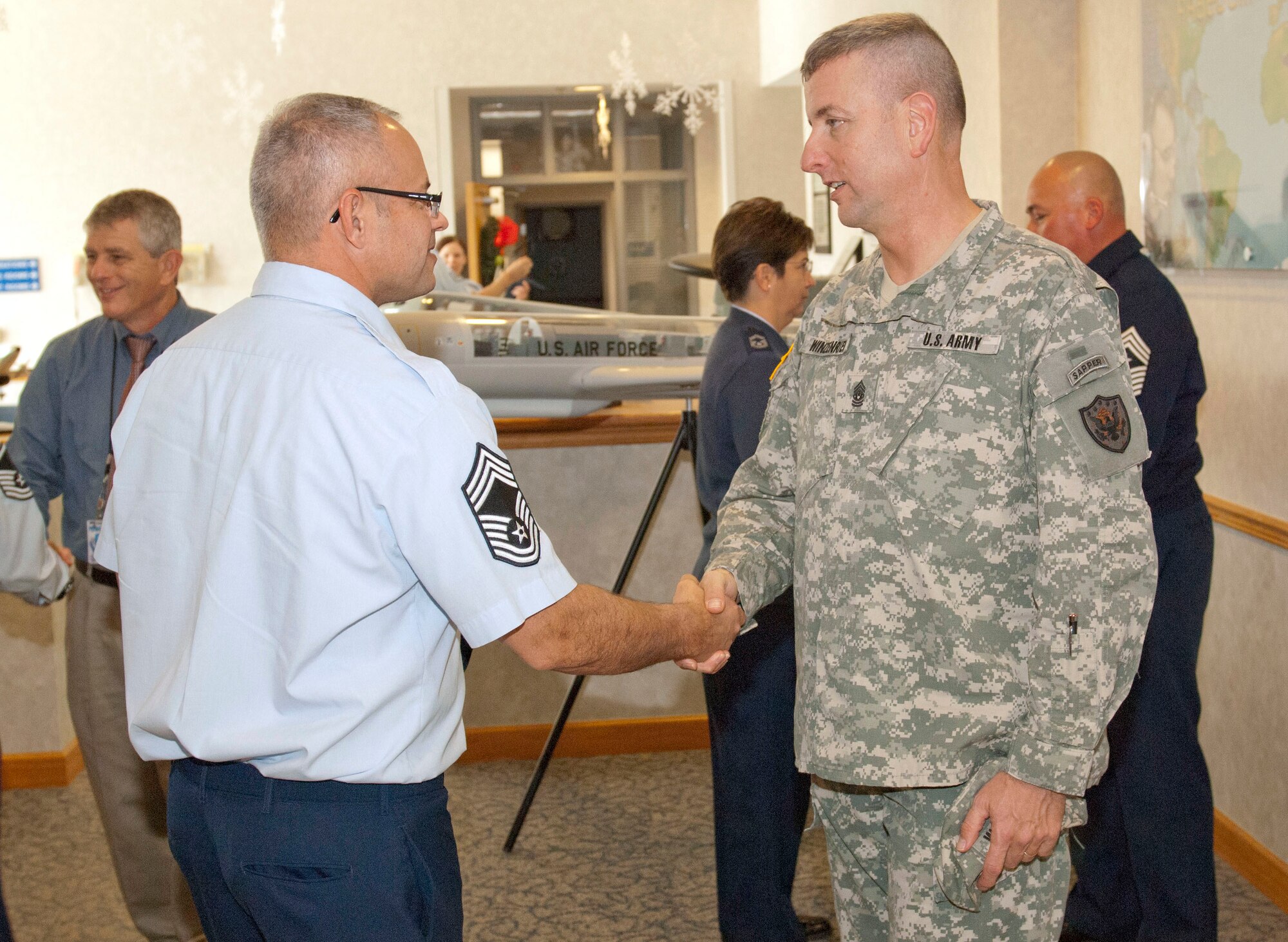 Army Command Sgt. Maj. Robert Winzenried shakes hands with Chief Master Sgt. Thane Stauffer, Air Forces Northern intelligence directorate, after an enlisted call at Tyndall Air Force Base, Fla., Dec. 19. This was Winzenried’s first visit to Tyndall since he took over as the top enlisted leader at the North American Aerospace Defense Command and U.S. Northern Command Sept. 15. In addition to hosting an enlisted call during his visit, he also had breakfast with some of the Continental U.S. NORAD Region-1st Air Force (AFNORTH)’s enlisted award winners and toured the command, meeting with enlisted members at each stop. (U.S. Air Force photo by Christopher Cokeing)