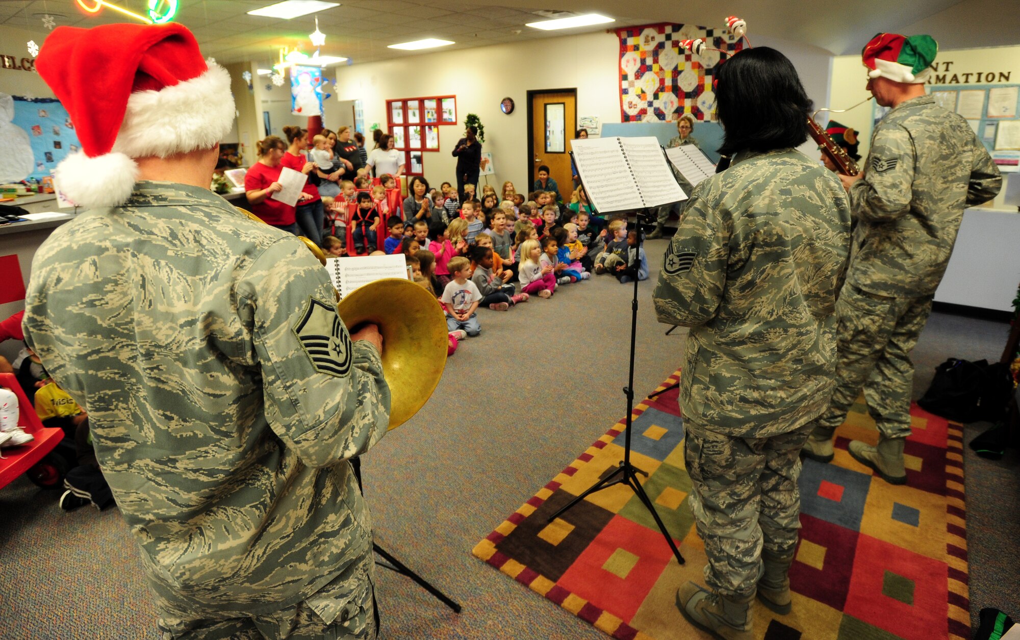 The Winds of Freedom woodwind quintet performs traditional holiday music at the child development center Dec. 16, 2011, McConnell Air Force Base, Kan. The quintet, part of the U.S. Air Force Heartland of America Band, Offutt Air Force Base, Neb., performed for more than 275 Airmen at 13 locations within the four base groups. (U.S. Air Force photos/ Airman 1st Class Armando Schwier-Morales)