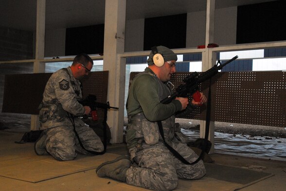 Prior to deploying in support of the POMLT 4 mission, members of the 171st Security Forces Squadron perform weapon qualification on the M-4 rifle and M-9 pistol. A police operational mentor and liaison team, POMLT4 will spend the next year training and teaching Afghan military and police on security tactics in Afghanistan. (National Guard photo by Tech. Sgt. Stacy Gault)