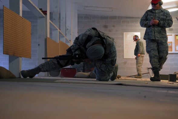 Prior to deploying in support of the POMLT 4 mission, members of the 171st Security Forces Squadron perform weapon qualification on the M-4 rifle and M-9 pistol. A police operational mentor and liaison team, POMLT4 will spend the next year training and teaching Afghan military and police on security tactics in Afghanistan. (National Guard photo by Tech. Sgt. Stacy Gault)
