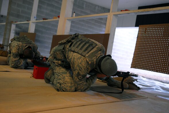 Prior to deploying in support of the POMLT 4 mission, members of the 171st Security Forces Squadron perform weapon qualification on the M-4 rifle and M-9 pistol. A police operational mentor and liaison team, POMLT4 will spend the next year training and teaching Afghan military and police on security tactics in Afghanistan. (National Guard photo by Tech. Sgt. Stacy Gault)