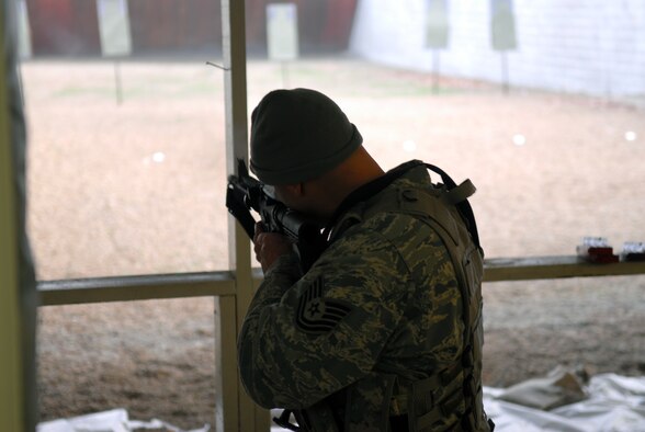 Prior to deploying in support of the POMLT 4 mission, members of the 171st Security Forces Squadron perform weapon qualification on the M-4 rifle and M-9 pistol. A police operational mentor and liaison team, POMLT4 will spend the next year training and teaching Afghan military and police on security tactics in Afghanistan. (National Guard photo by Tech. Sgt. Stacy Gault)