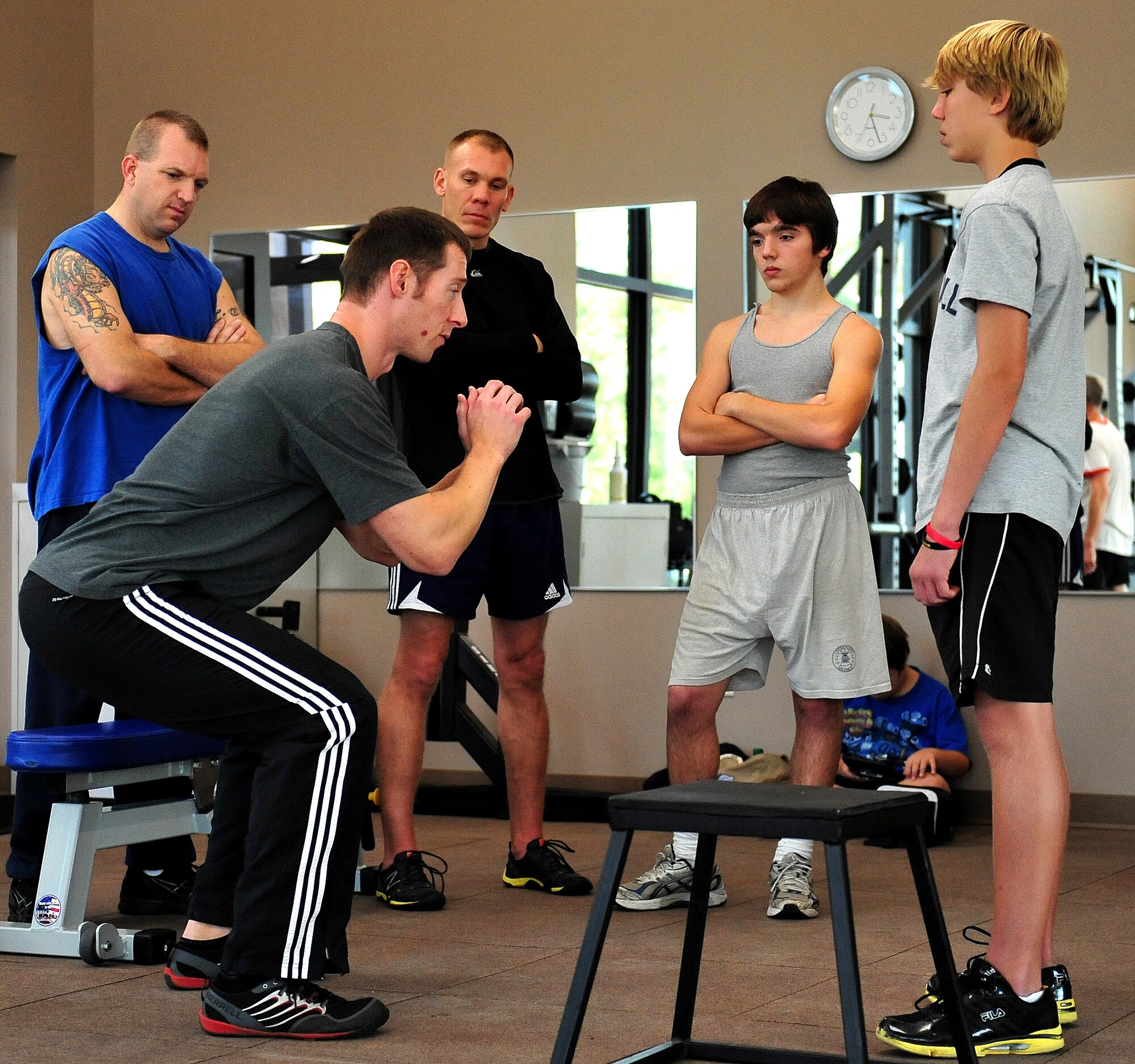 Ben Gleason, Military Fitness Program Liaison, teaches Master Sgt. Chris Calhoun and his son how to box jump. Special training was provided during family strength training classes Dec. 19 to 20 at the Eglin Field House. Parents and youth, ages 13 to 18, were taught free weight movements.  For more information on future events, call 882-6028 or send an e-mail to benjamin.gleason@eglin.af.mil. (U.S. Air Force photo/Randy Gon)