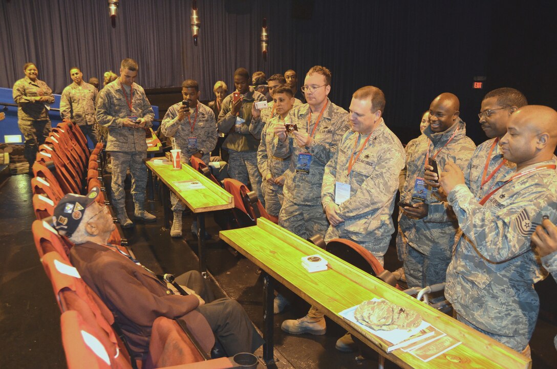 Documented Original Tuskegee Airman Thomas Ellis talks with Servicemembers from the 433rd Airlift Wing prior to a screening of "Double Victory" a documentary by Lucasfilm, Dec. 10 at the Santikos Rialto Theatre in San Antonio, Texas. "Double Victory" chronicles the experiences and personal plight of the Tuskegee Airmen during World War II. (U.S. Air Force photo/ Senior Master Sgt. Minnie Jones) 