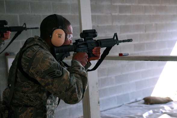 Prior to deploying in support of the POMLT 4 mission, members of the 171st Security Forces Squadron perform weapon qualification on the M-4 rifle and M-9 pistol. A police operational mentor and liaison team, POMLT4 will spend the next year training and teaching Afghan military and police on security tactics in Afghanistan. (National Guard photo by Tech. Sgt. Stacy Gault)