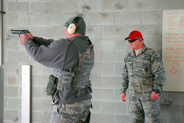Prior to deploying in support of the POMLT 4 mission, members of the 171st Security Forces Squadron perform weapon qualification on the M-4 rifle and M-9 pistol. A police operational mentor and liaison team, POMLT4 will spend the next year training and teaching Afghan military and police on security tactics in Afghanistan. (National Guard photo by Tech. Sgt. Stacy Gault)