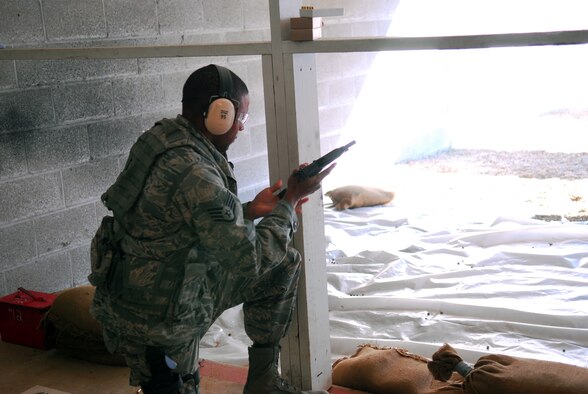 Prior to deploying in support of the POMLT 4 mission, members of the 171st Security Forces Squadron perform weapon qualification on the M-4 rifle and M-9 pistol. A police operational mentor and liaison team, POMLT4 will spend the next year training and teaching Afghan military and police on security tactics in Afghanistan. (National Guard photo by Tech. Sgt. Stacy Gault)