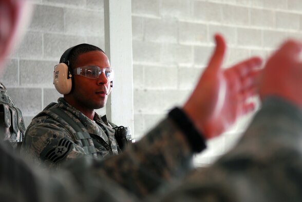 Prior to deploying in support of the POMLT 4 mission, members of the 171st Security Forces Squadron perform weapon qualification on the M-4 rifle and M-9 pistol. A police operational mentor and liaison team, POMLT4 will spend the next year training and teaching Afghan military and police on security tactics in Afghanistan. (National Guard photo by Tech. Sgt. Stacy Gault)