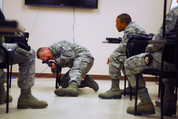 Prior to deploying in support of the POMLT 4 mission, members of the 171st Security Forces Squadron perform weapon qualification on the M-4 rifle and M-9 pistol. A police operational mentor and liaison team, POMLT4 will spend the next year training and teaching Afghan military and police on security tactics in Afghanistan. (National Guard photo by Tech. Sgt. Stacy Gault)