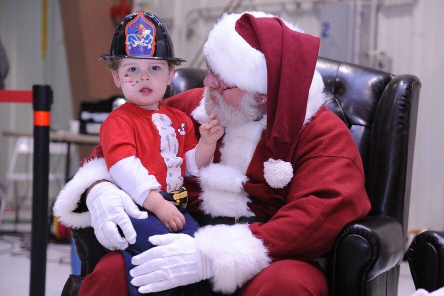 Santa asks Skylor Burkett what he would like for Christmas at the Mission Support Group Children’s Christmas Party on Seymour Johnson Air Force Base, N.C., Dec. 17, 2011. Santa Claus has been participating in Christmas parties here since 1971 to show his support for military kids. (U.S. Air Force photo by Senior Airman Whitney Stanfield) 