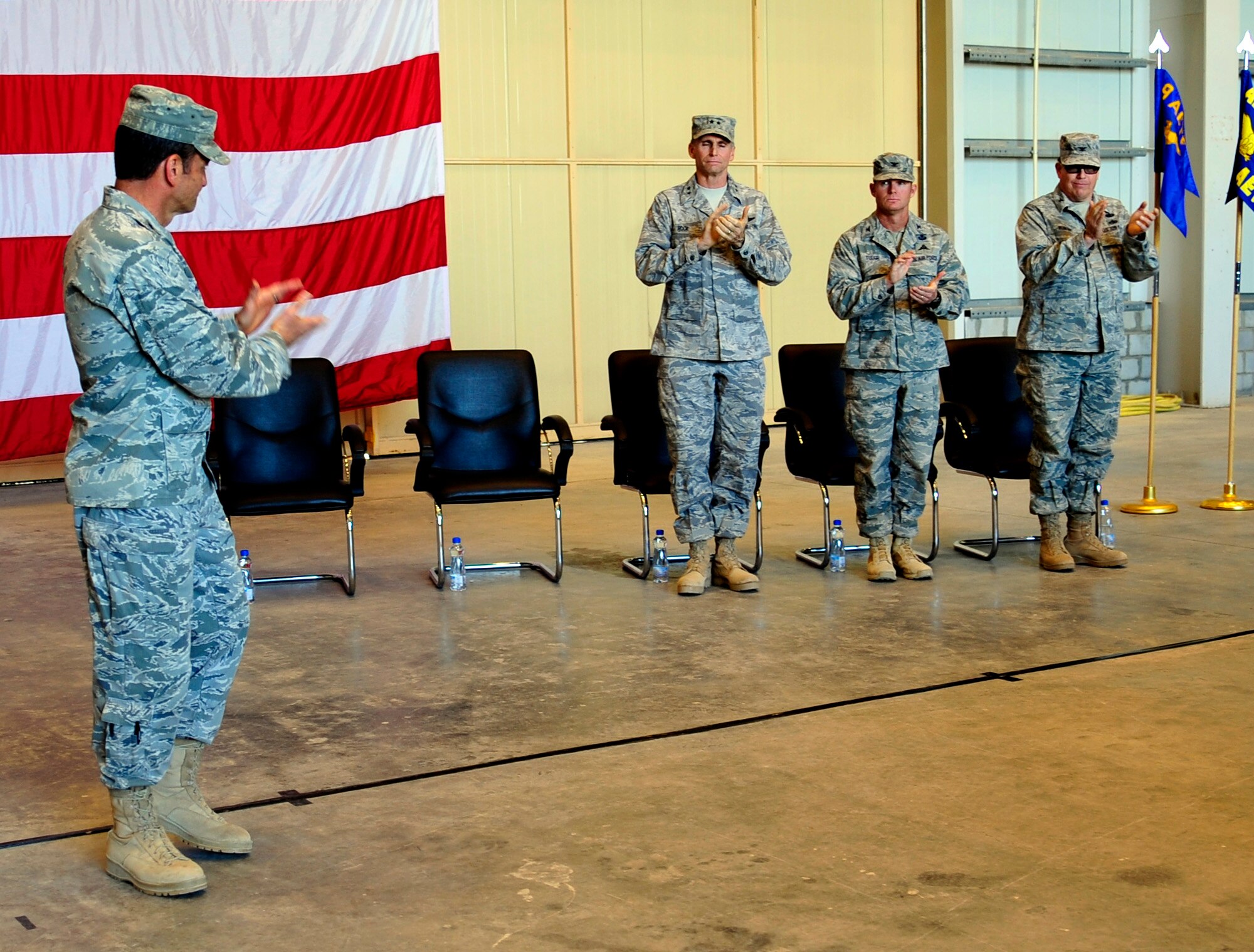Maj. Gen. Russ Handy, commander, 9th Air and Space Expeditionary Task Force-Iraq, applauds his team of commanders during the inactivation ceremony of the 9th AETF-I, 321st Air Expeditionary Wing, the 467th Air Expeditionary Group, and the 368th Expeditionary Air Support Operations Group at an undisclosed location in Southwest Asia, Dec. 18, 2011.  The ceremony took place hours after the last remaining U.S.military forces drove across the Iraqi border per the Iraq and U.S. 2008 Security Agreement that required all U.S. service members to be out of the country by  Dec. 31 . Since 2003, more than 1 million Airmen, Soldiers, Sailors and Marines have served in Iraq. (U.S. Air Force photo/Master Sgt. Cecilio Ricardo)