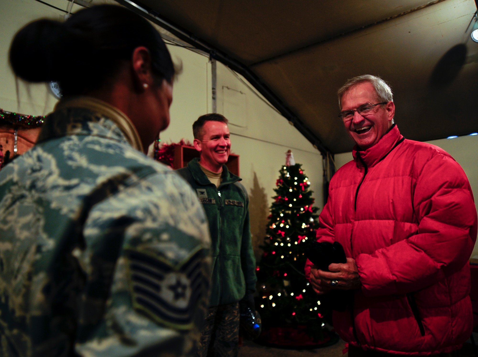 Visiting the Transit Center at Manas, Kyrgyzstan just before Christmas, retired Lt. Gen. Christopher Kelly share a laugh with Col. James Jacobson and an Airman from the 376th Air Expeditionary Wing Dec. 20, 2011. Kelly was the first 376th AEW commander in 2001, Jacobson is the current Commander. (U.S. Air Force photo/Staff Sgt. Angela Ruiz)
