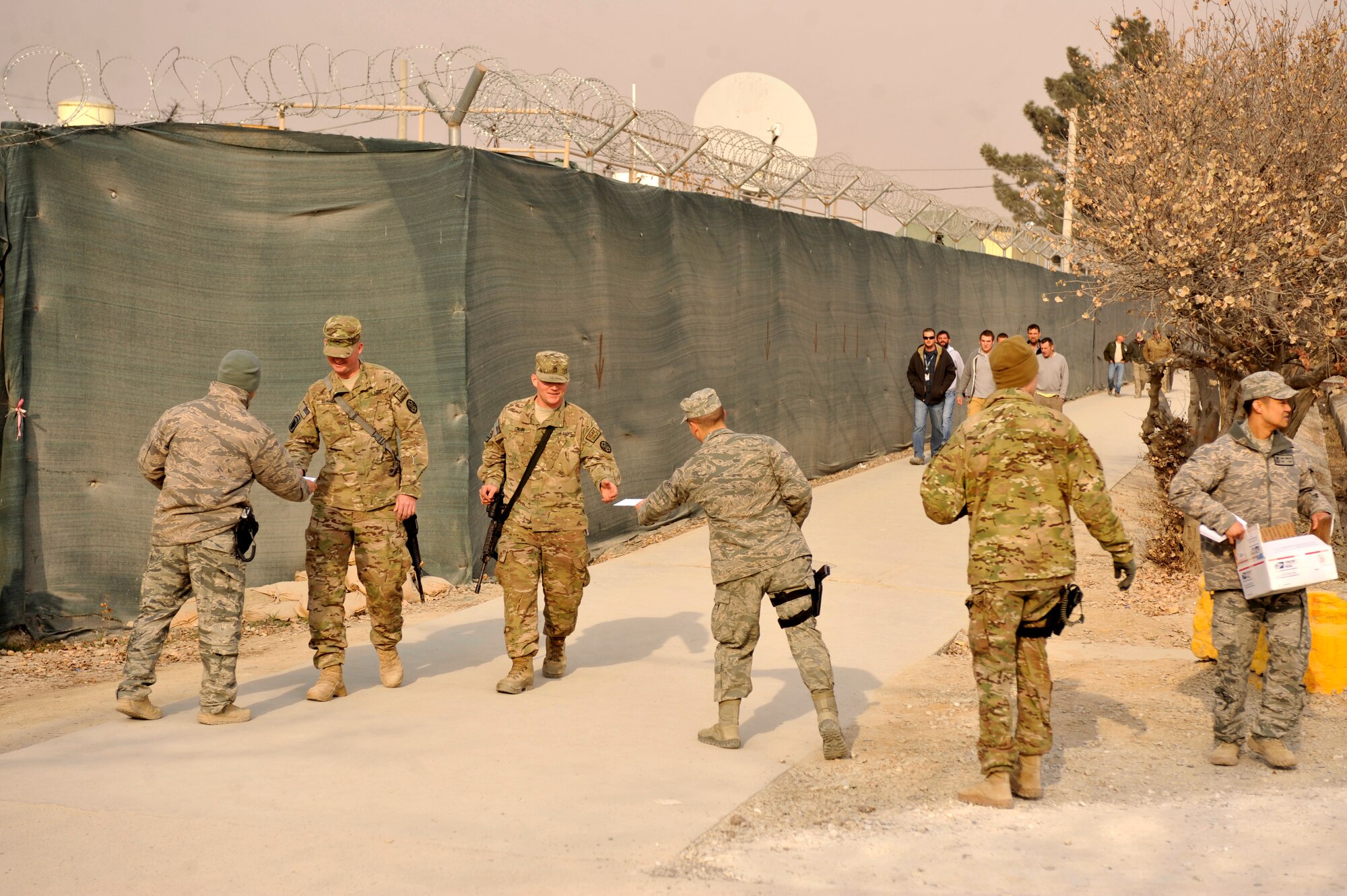 BAGRAM AIRFIELD, Afghanistan— Volunteers with Operation Merry Christmas pass out Christmas cards at Bagram Airfield, Afghanistan, Dec. 19, 2011. Operation Merry Christmas was a program sponsored by Angel Heart Ministry that was designed to bring holiday cheer to deployed Airmen by handing out more than 14,000 Christmas cards.  (U.S. Air Force photo/ Airman 1st Class Ericka Engblom)

