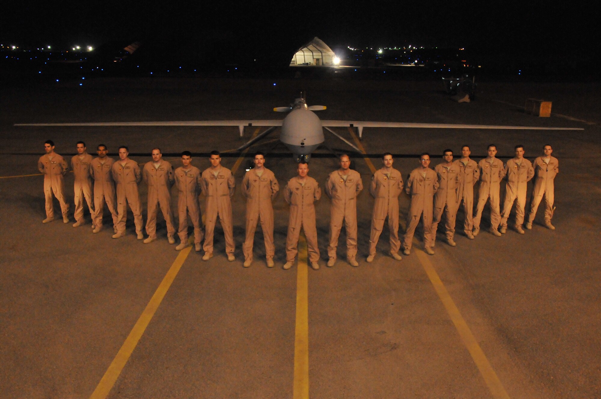 Lieutenant Col. Erik Drake, 46th Expeditionary Reconnaissance Squadron commander, stands with assigned Airmen in front of a MQ-1B Predator unmanned aerial system at an undisclosed location in Southwest Asia Dec. 15, 2011.The MQ-1B was the last unmanned aircraft to leave Iraqi airspace. They are piloted from outside the theater, but are launched and recovered by Airmen of the 46th ERS. (U.S. Air Force photo/Master Sgt. Paul Mann)