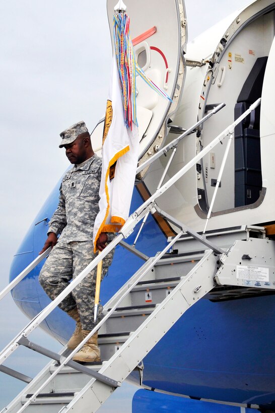 Army Command Sgt. Maj. Joseph R. Allen carries the U.S. Forces Iraq  colors back onto U.S. soil on Joint Base Andrews, Md., Dec. 20, 2011.