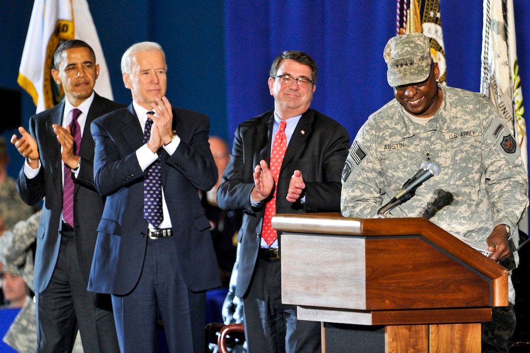 From left, President Barack Obama, Vice President Joe Biden and Deputy Defense Secretary Ashton B. Carter applaud as Army Gen. Lloyd J. Austin III, the last commander of U.S. Forces Iraq, steps to the podium on Joint Base Andrews, Md., Dec. 20, 2011.