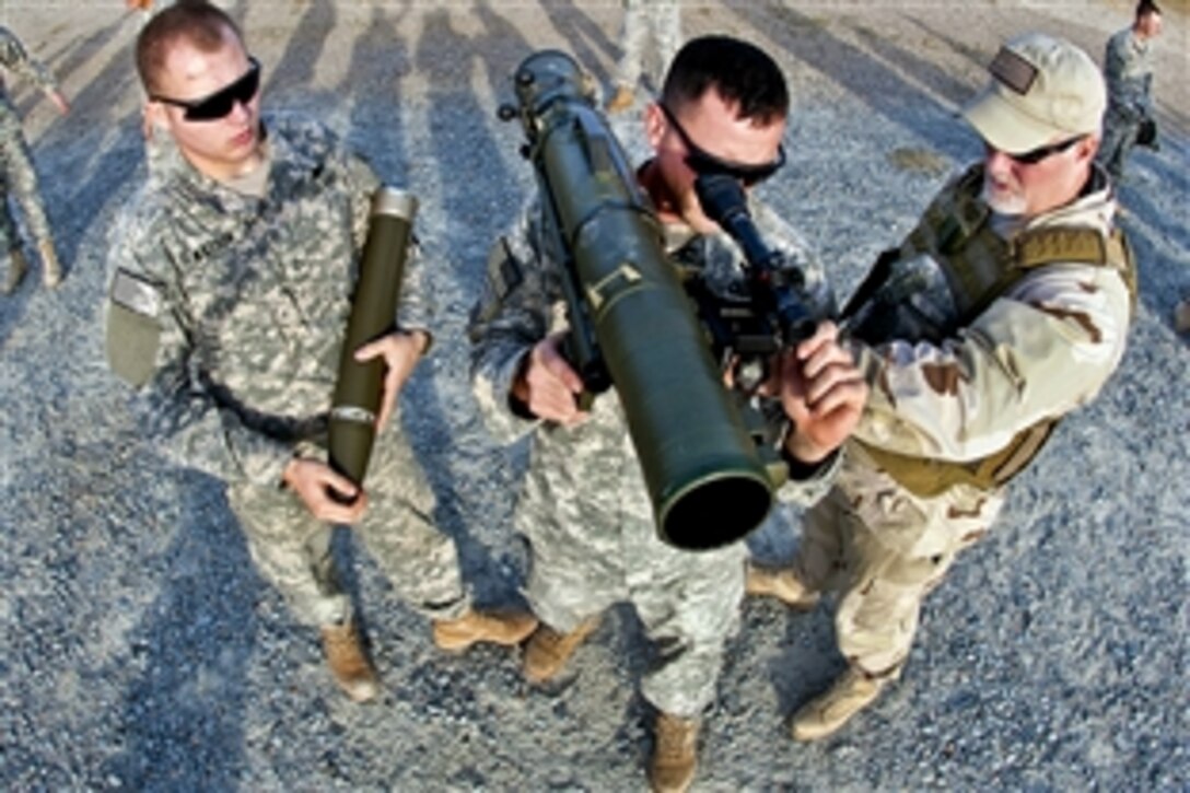 A civilian instructor coaches two paratroopers on how to use a Carl Gustav M3 84mm recoilless rifle during a certification course on Fort Bragg, N.C., Dec. 6, 2011. The paratroopers are assigned to the 82nd Airborne Division's 1st Brigade Combat Team. The multi-role weapon consists of a light artillery tube that can be used against armor, fortifications and personnel.