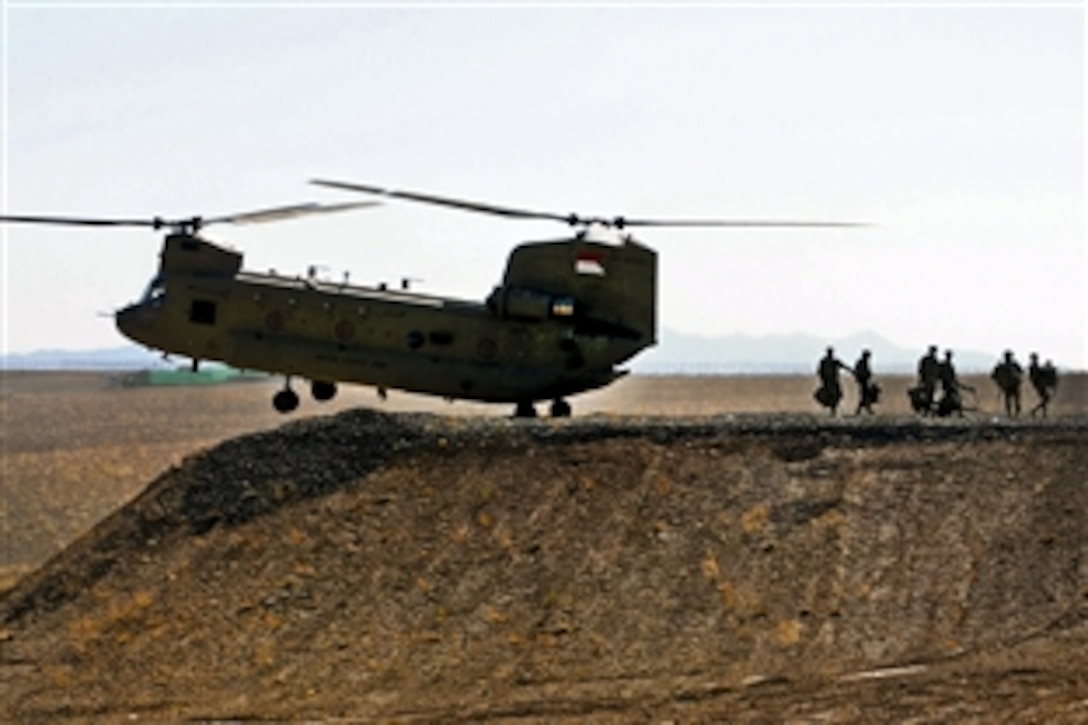 U.S. Army soldiers depart a CH-47 Chinook helicopter during winter Spur Ride on Forward Operating Base Sharana, Paktika province, Afghanistan, Dec. 8, 2011. The soldiers are assigned to 1st Battallion, 227th Aviation Regiment. The Spur Ride is a tradition dating back to the beginning of the U.S. Cavalry, where troopers prove their tactical and technical skills, leadership, and teamwork over several days to earn the right to wear silver cavalry spurs.