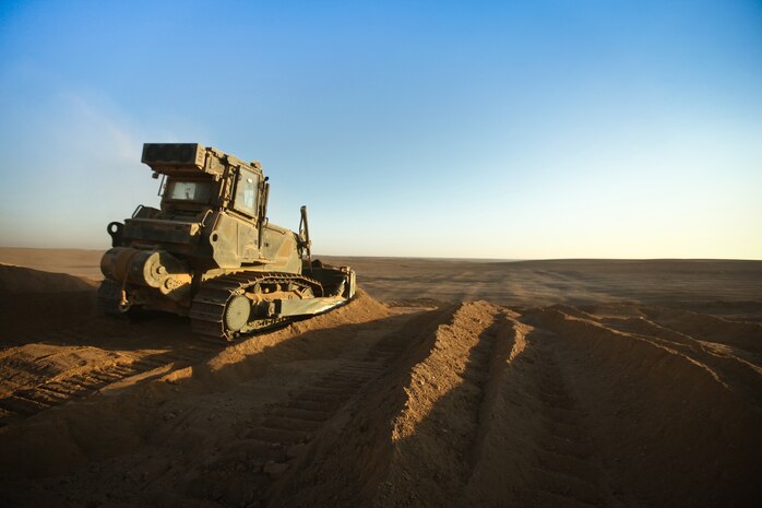 A bulldozer pushes down a berm at Firebase Saenz, Helmand province, Dec. 13. FB Saenz is the first of several patrol bases being demilitarized by the Marines of 9th Engineer Support Battalion throughout the month of December.