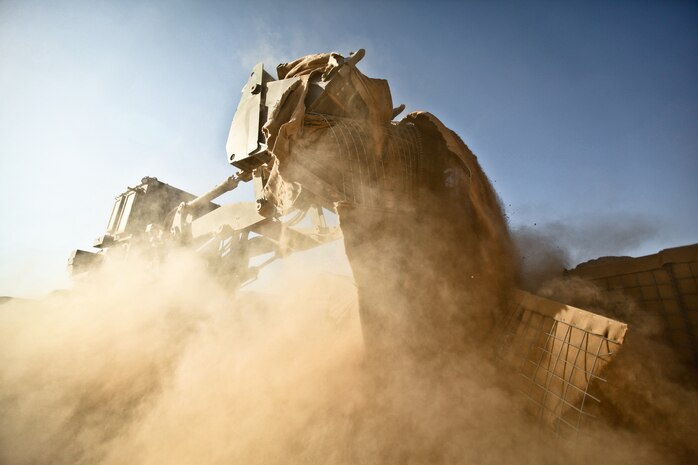 A tractor pulls up a piece of HESCO barrier at Firebase Saenz, Helmand province, Dec. 14. FB Saenz is the first of several patrol bases being demilitarized by the Marines of 9th Engineer Support Battalion throughout the month of December.