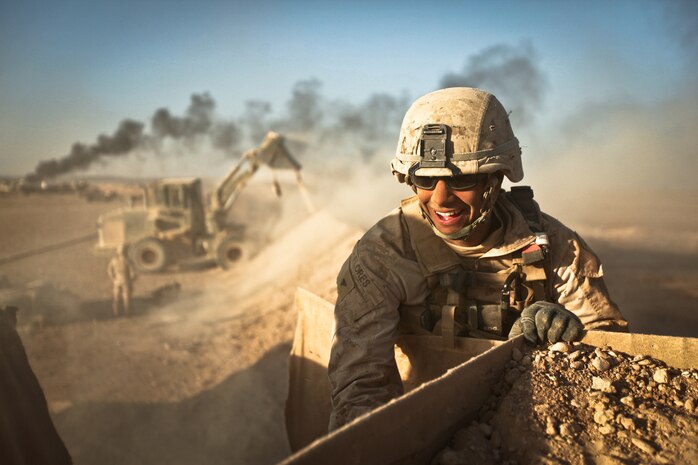 Lance Cpl. Paul Flores, a combat engineer with Alpha Company, 9th Engineer Support Battalion, and a native of Moundsville, W. Va., helps empty the sand from a dismantled HESCO barrier at Firebase Saenz, Helmand province, Dec. 14. FB Saenz is the first of several patrol bases being demilitarized by the Marines of 9th ESB throughout the month of December.