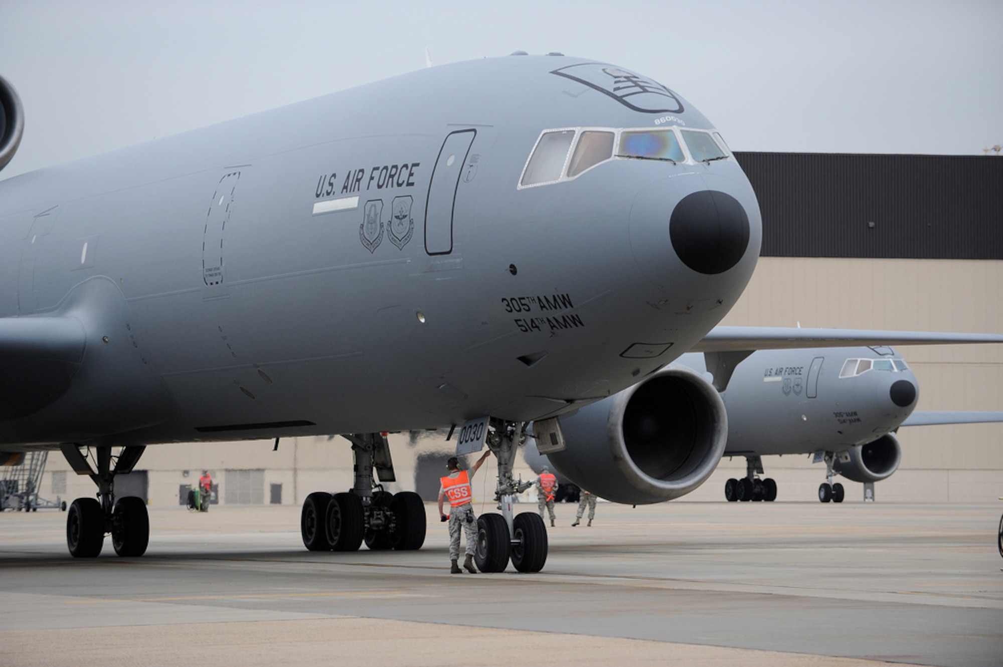 Maintainers with the 305th Air Mobility Wing conduct final preflight checks before the ‘Elephant Walk’ kicks off Dec. 20 here. An ‘Elephant Walk’ is a fundamental training element when preparing for Global Strike Missions. This was the first ‘Elephant Walk’ in nearly five years, with the 305th Air Mobility Wing launching all 12 KC-10 Extenders on the ramp within a 30-minute time period. Members of the 32nd and 2nd Air Refueling Squadrons, as well as members of the 305th and 514th Air Mobility Wings, participated in the Employment Defense and Global Engagement exercise. (U.S. Air Force photo by Russell Meseroll/Released)
