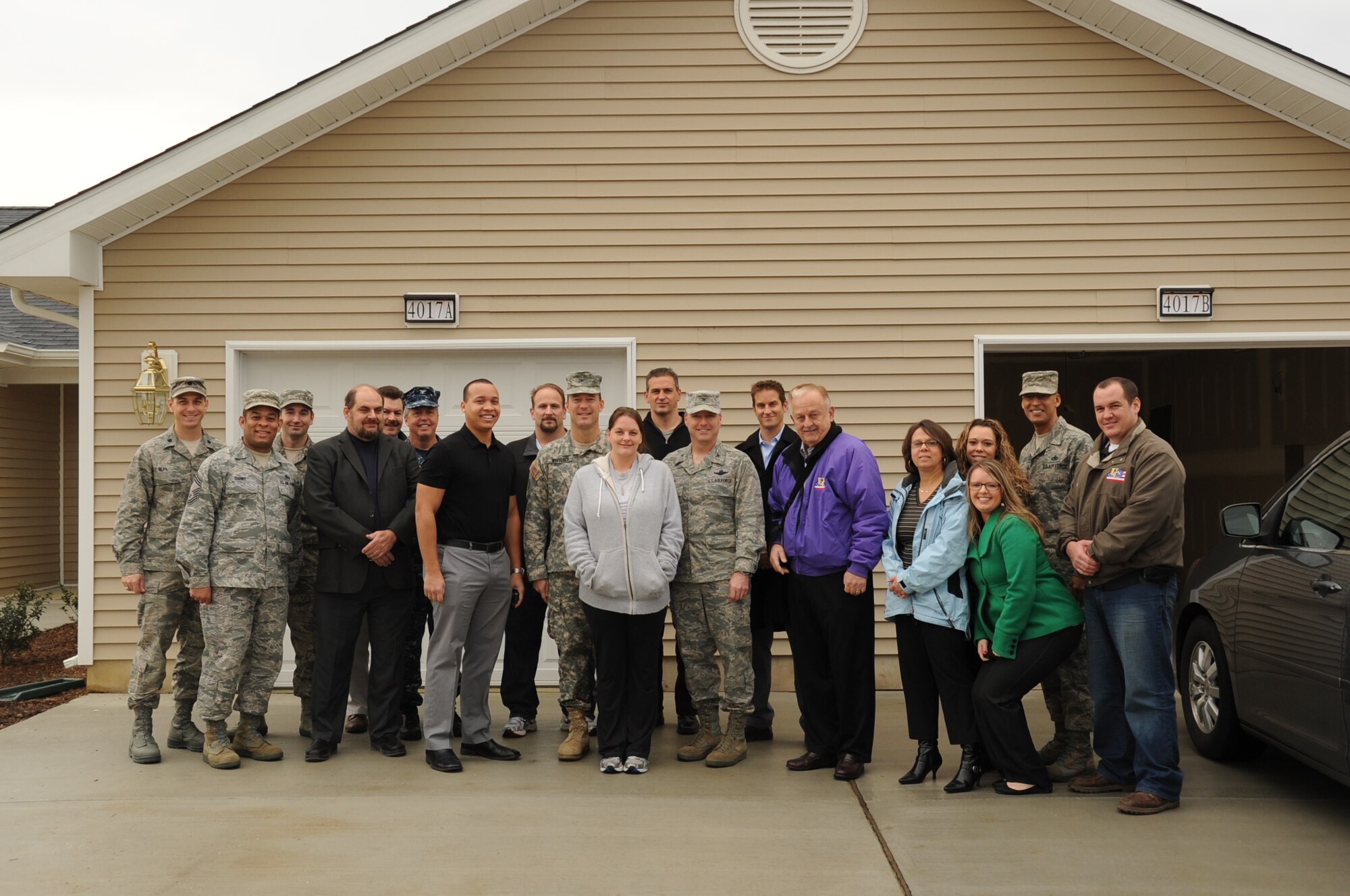 Base and United Communities leadership welcome Amanda Clegg, spouse of deployed Master Sgt. Brian Clegg and mother of four children, into her brand new base home four days before Christmas. The Clegg family was not expecting to move into their home on Falcon Courts North until next year, but United Communities finished its last homes a year early. The home was not any ordinary home, but a handicap-accessible one made specifically for Amanda’s youngest child, Colton, who is 9 and a paraplegic. (U.S. Air Force photo by Airman 1st Class Dennis Sloan/Released)