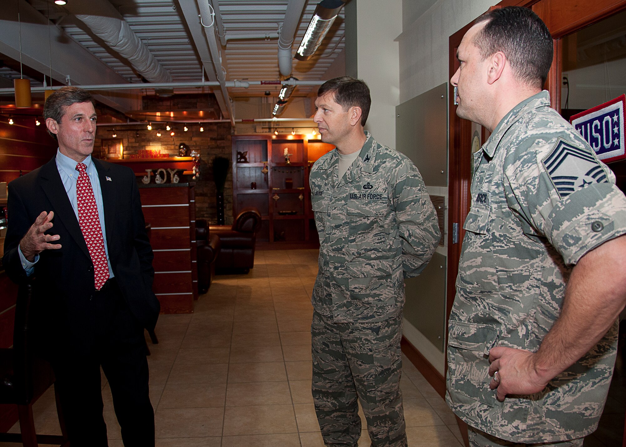 Rep. John Carney of Delaware talks with Col. Thomas Joyce, Air Force Mortuary Affairs Operations commander, and Chief Master Sgt. David Fish, AFMAO chief enlisted manager at the Charles C. Carson Center for Mortuary Affairs, Dover Air Force Base, Del., Dec. 21, 2011. The representative toured the mortuary to gain a better understanding of the mission. (U.S. Air Force photo/Staff Sgt. Agustin G. Salazar)