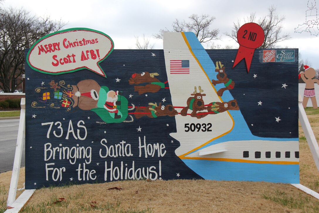The 73rd Airlift Squadron took second place in the Scott Air Force Base holiday billboard contest.  Flight attendants Tech. Sgts. Oriel Rodriguez, Danielle Sloan,  Brandy Dukart and Staff Sgt. Andrea Korobey designed and painted the billboard.  Also, the 73rd AS was presented a $150 gift card.  (U.S. Air Force photo/Senior Airman Jessica Davila-Caba)