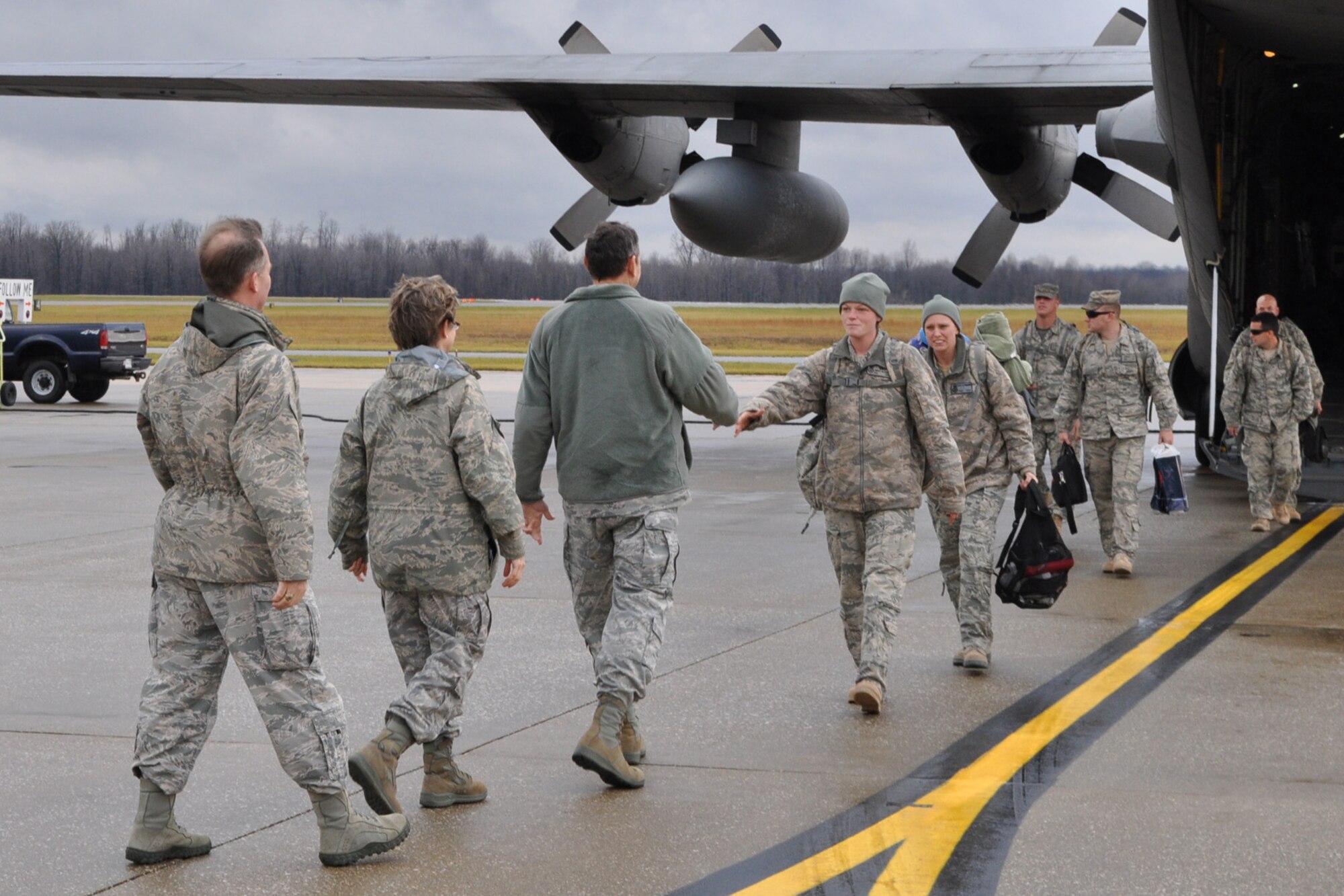 YOUNGSTOWN AIR RESERVE STATION, Ohio – Air Force Reserve Capt. Scott Allen, 910th Mission Support Group executive officer, Col. Teresa Hams, 910th MSG commander and Col. Reinhard Schmidt, 910th Airlift Wing commander, welcome home six members of the 910th Security Forces Squadron on the flightline here, Dec. 21, 2011. The 910th SFS Citizen Airmen, whose duties included providing base security at Shindand Air Base, the second largest airfield in Afghanistan, returned to YARS after a six-month deployment. U.S. Air Force photo by Master Sgt. Bob Barko Jr.