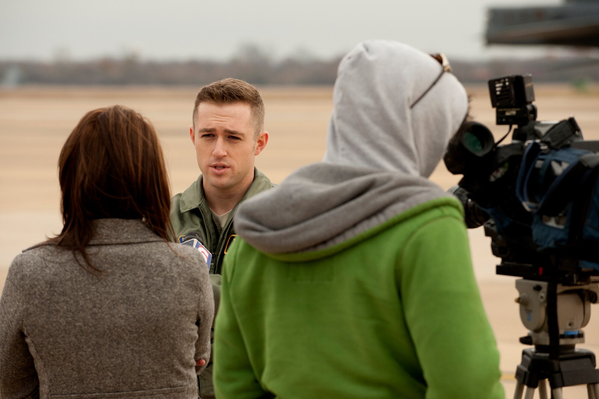 U.S. Air Force 2nd Lt. Maverick Lewis, 11th Bomb Squadron copilot, is interviewed by KTAL Channel 6 news reporter Leslie Draffin for a Barksdale Profile segment, Barksdale Air Force Base, La., Dec. 21, 2011. The segment highlights Lewis and his class's completion of the B-52 aircrew training school. (U.S. Air Force photo by Master Sgt. Greg Steele/Released)
