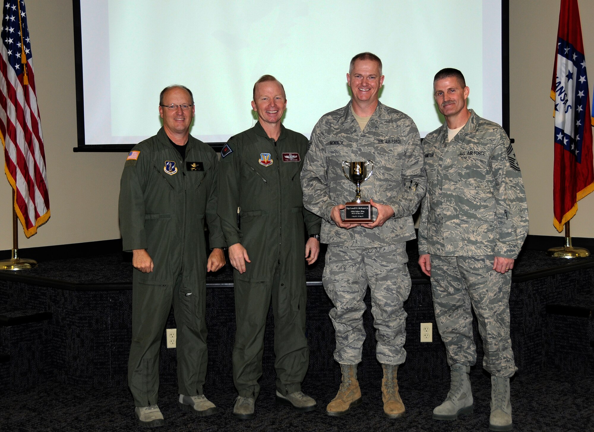 From left: Brig. Gen. Dwight Balch, Arkansas Air National Guard commander; Col. Tom Anderson, 188th Fighter Wing commander; Staff Sgt. Lowell McKenzie Jr.; and Chief Master Sgt. Asa Carter, 188th command chief. McKenzie, a member of the 188th Civil Engineer Squadron, was named Outstanding Noncommissioned Officer of the Year during a commander’s call Dec. 3. (U.S. Air Force photo by Airman 1st Class Hannah Landeros/188th Fighter Wing Public Affairs)

