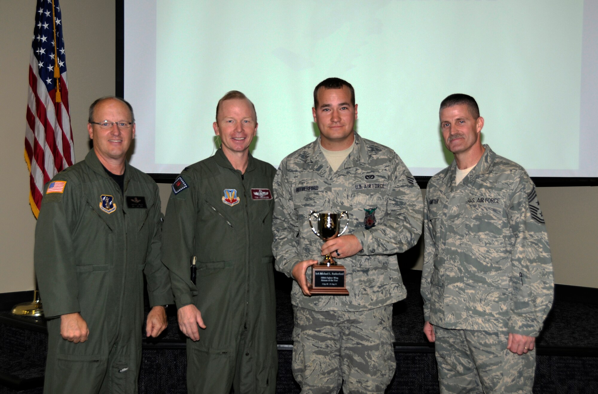 From left: Brig. Gen. Dwight Balch, Arkansas Air National Guard commander; Col. Tom Anderson, 188th Fighter Wing commander; Senior Airman Michael Rutherford; and Chief Master Sgt. Asa Carter, 188th command chief. Rutherford, a member of the 188th Fire Emergency Services Flight, was named the 188th’s Outstanding Airman of the Year during a commander’s call Dec. 3. (U.S. Air Force photo by Airman 1st Class Hannah Landeros/188th Fighter Wing Public Affairs)



