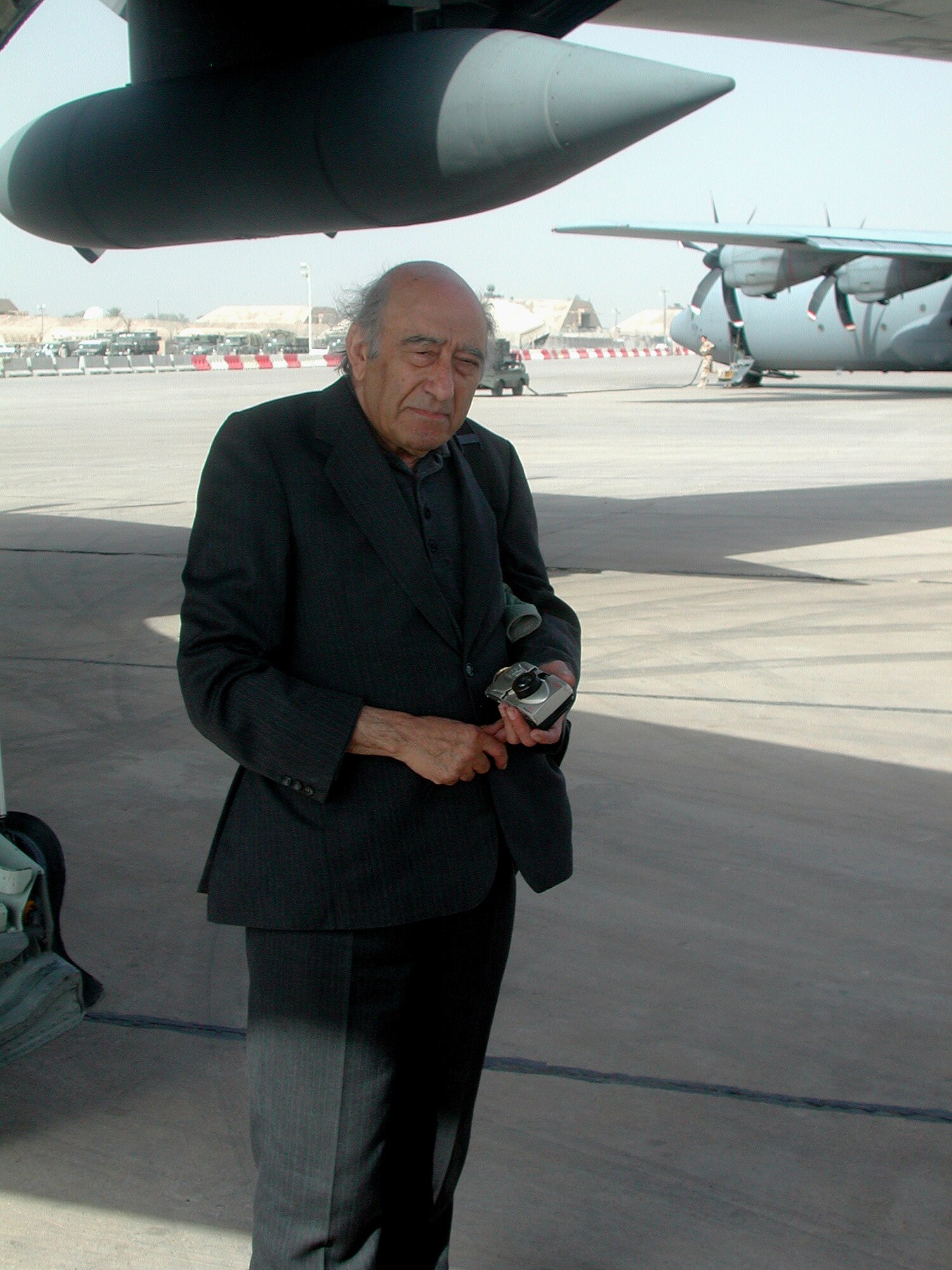 Khalid Kishtainy steps off a C-130 Hercules at Baghdad International Airport, Iraq, on Oct. 21, 2003. Kishtainy is an Iraqi novelist and in 2003 also a columnist for the Asharq Al-Awsat Arabic newspaper in London. Before 2003, he was last in Baghdad in 1989 before he left for fear of his life. The former Saddam Hussein regime had two death sentences on Kishtainy for a book he wrote about the regime. The author grew up in Baghdad, and he considers it his hometown. (U.S. Air Force photo/Master Sgt. Scott T. Sturkol)