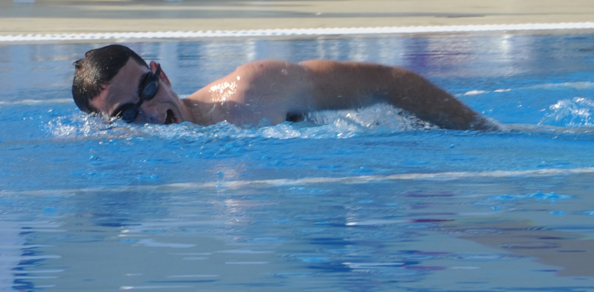 SOUTHWEST ASIA - An Airman swims a practice lap Dec. 18, 2011, during the Holiday Games. In addition to swimming, teams played soccer, football, softball, billiards, table tennis and even competed in a video game competition. Members of the French air force participated in the combined cultural event as well.  (U.S. Air Force photo/Staff Sgt. J.G. Buzanowski)