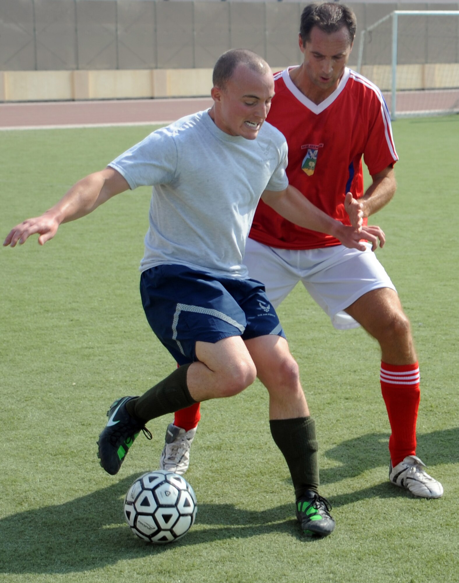 SOUTHWEST ASIA - An Airman defends the ball in a soccer match against a French team Dec. 18, 2011, during the Holiday Games. In addition to soccer teams played basketball, football, softball, billiards, table tennis and even competed in a video game competition. (U.S. Air Force photo/Staff Sgt. J.G. Buzanowski)