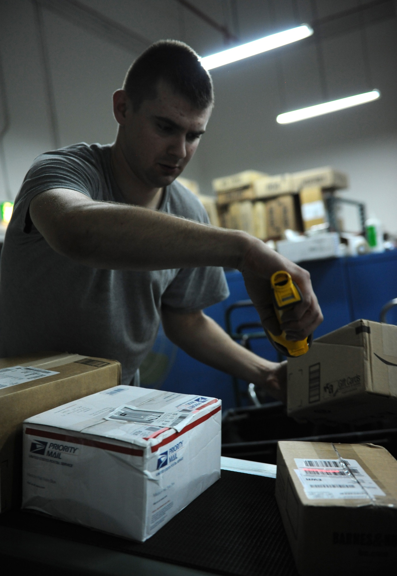 SOUTHWEST ASIA – Senior Airman Alex Bedtelyon, 379th Expeditionary Communications Squadron Mail Control Activity courier and native of West Branch, Mich., scans mail as it is unloaded from a cargo truck here Dec. 21, 2011. The 379th ECS MCA processed more than 48,000 pounds of mail Dec. 19-20 -- more mail than they normally process in an entire week. Bedtelyon is deployed from Misawa Air Base, Japan. (U.S. Air Force photo/Staff Sgt. Nathanael Callon)