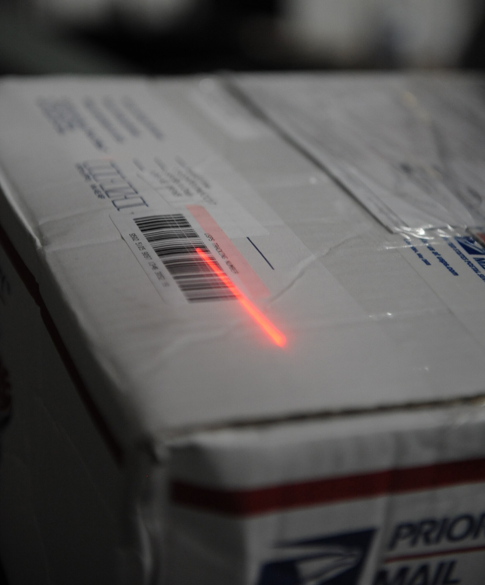 SOUTHWEST ASIA – A box is scanned after being unloaded from a cargo truck here Dec. 21, 2011. The 379th Expeditionary Communications Squadron Mail Control Activity processed more than 48,000 pounds of mail Dec. 19-20, just in time for the holiday season. (U.S. Air Force photo/Staff Sgt. Nathanael Callon)