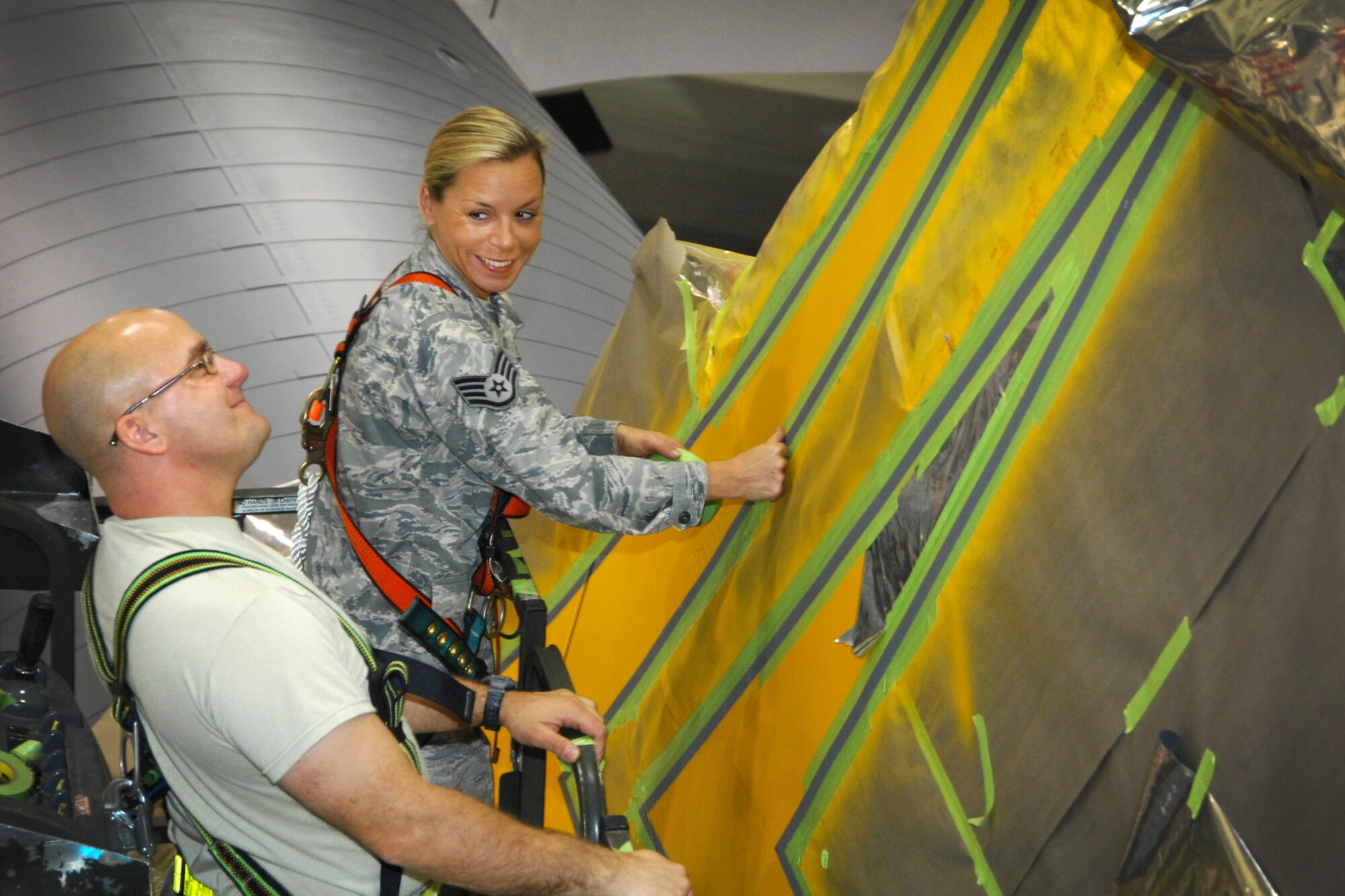 TSgt. Tony Lagore, 191st Maintenance Squadron, admires the new striping applied to a KC-135 Stratotanker at Selfridge Air National Guard Base, Mich., Dec. 13, 2011. Lagore, SSgt Tracy Lindsay-Apple and other Airman of the unit painted the aircraft with a checkerboard stripe and related detailing that honors both the heritage of the Michigan Air National Guard and the former Strategic Air Command, which once operated at Selfridge. (U.S. Air Force photo by John S. Swanson)