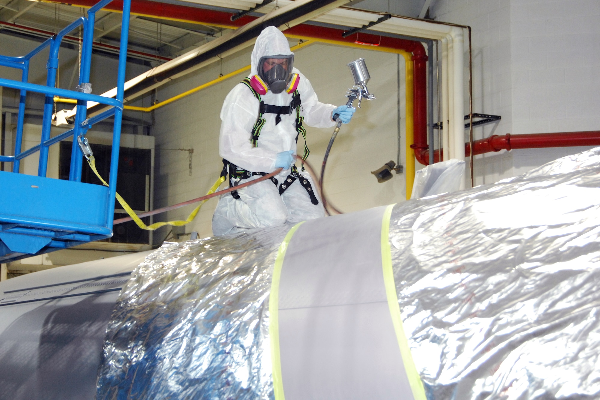 SSgt. Brian Harris, 191st Maintenance Squadron, prepares to apply the first coat of paint to the skin of a KC-135 Stratotanker at Selfridge Air National Guard Base, Mich., Dec. 13, 2011. The aircraft was painted with a checkerboard stripe that honors both the heritage of the Michigan Air National Guard and the former Strategic Air Command, which once operated at Selfridge. (U.S. Air Force photo by John S. Swanson)