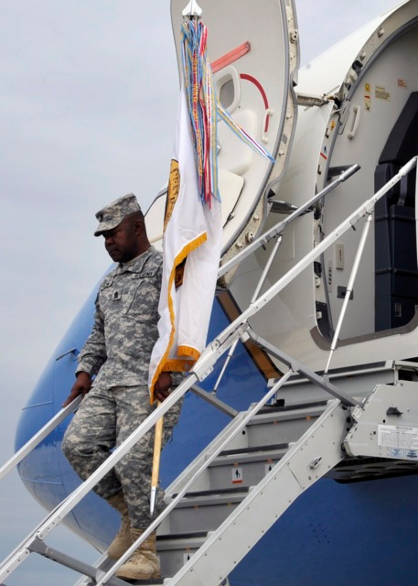 United States Forces - Iraq Command Sgt. Maj. Joseph R. Allen carries the USF-I colors back onto U.S. soil at Joint Base Andrews, Md., Dec. 20. The Ceremony marks the end of the second longest war in U.S. history. (U.S. Air Force photo/ Senior Airman Perry Aston)
