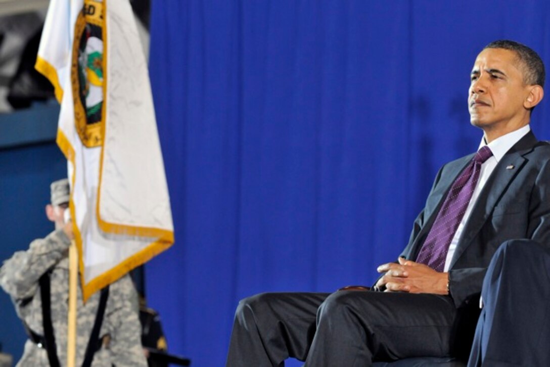 President Obama listens to Gen. Martin Dempsey's speech  during the return of the United States Forces - Iraq colors ceremony, Dec 20, 2011 at Joint Base Andrews, Md. The Ceremony marks the end of the 2nd longest war in U.S. History. (U.S. Air Force Photo/Senior Airman Perry Aston)